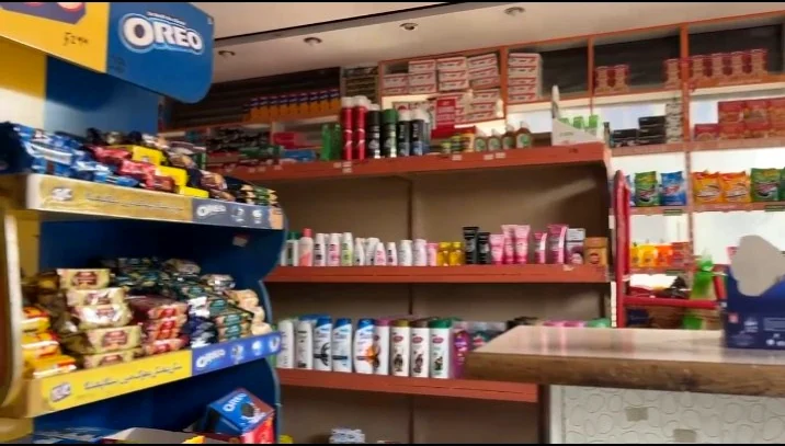 Shelves stocked with snacks and everyday products inside Saim Super Store
